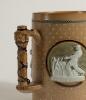Doulton Lambeth stoneware tyg. Large and impressive three handled tyg with three moulded relief vignettes of cricketers, a batsman, a fielder and wicket keeper in white on a brown background, the sides highly decorated with impressed floral motifs, the ha - 3