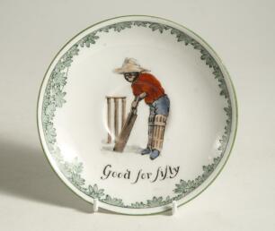 &lsquo;Good for Fifty&rsquo; Royal Doulton Black Boy saucer, entitled &lsquo;Good for Fifty&rsquo; printed with a boy in red shirt and a floppy hat in batting pose in front of the wicket to centre. Green floral decoration to edge. 5.5&rdquo; diameter. Doulton backstamp and number &lsquo;E43