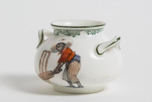 &lsquo;There&rsquo;s Style&rsquo;. Royal Doulton Black Boy miniature two handled bulbous pot, with printed image of a boy in red shirt and a floppy hat in batting pose in front of the wicket to one side and to the other, a crest with &lsquo;The All Black Team&rsquo;. Green floral deco