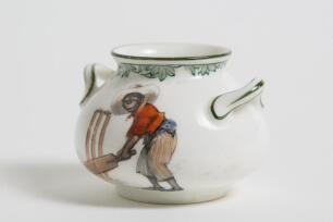 &lsquo;There&rsquo;s Style&rsquo;. Royal Doulton Black Boy miniature two handled bulbous pot, with printed image of a boy in red shirt and a floppy hat in batting pose in front of the wicket to one side and to the other, a crest with &lsquo;The All Black Team&rsquo;. Green floral deco