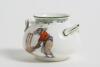 &lsquo;There&rsquo;s Style&rsquo;. Royal Doulton Black Boy miniature two handled bulbous pot, with printed image of a boy in red shirt and a floppy hat in batting pose in front of the wicket to one side and to the other, a crest with &lsquo;The All Black Team&rsquo;. Green floral deco