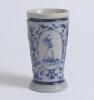 Westerwald stoneware cricket beaker, moulded in relief with three cameo panels of a batsman, after W.G. Grace, in different poses. The body highly decorated with vine and sprig decoration in cobalt blue on a grey background, with the figures highlighted i - 2