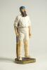 &lsquo;W.G. Grace&rsquo;?. Large modern figure of a bearded batsman wearing a blue and red hooped cap with bat and gloves in hands. The figure stands on grass base and signed &lsquo;Peter Mook 98&rsquo;. Approx 14.5&rdquo; tall. VG
