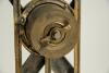 Cricket clock. A Victorian brass mantel clock. The case in the form of a set of stumps with crossed bats and ball on an oval naturalistic case base with bun feet. Dial with gilded centre. Approximately 6.5&rdquo; high by 5&rdquo; wide. British Union Clock Company sta - 2