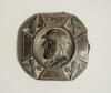 &lsquo;The Champion&rsquo;. Early brass cricket belt buckle of square form with rounded corner with head and shoulders image of a bearded cricketer wearing a bowler style hat with the legend &lsquo;The Champion&rsquo; to the hat band. The image of the cricketer at the centre of 
