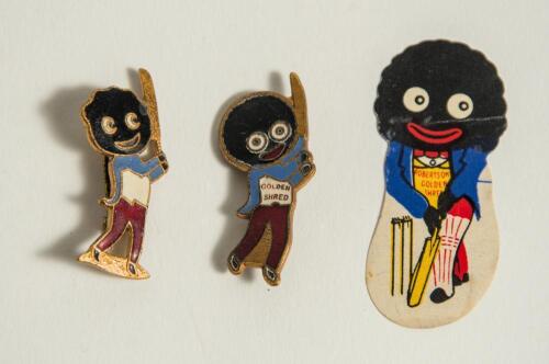 Robertson Golden Shred. Two metal golly cricketing lapel pin badges, each with maker&rsquo;s name to verso for Fattorini of Birmingham. 1.5&rdquo; tall. Sold with a similar paper golly label, 2&rdquo; tall. Good condition. Qty 3.