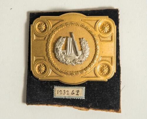 Cricket belt buckle. An excellent oblong shaped belt buckle in soft gilt metal overlaid with silver metal feature to centre, the circular centre decorated with bat, stumps and ball within a laurel wreath, the outer borders with attractive decorative sun s