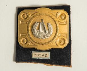 Cricket belt buckle. An excellent oblong shaped belt buckle in soft gilt metal overlaid with silver metal feature to centre, the circular centre decorated with bat, stumps and ball within a laurel wreath, the outer borders with attractive decorative sun s