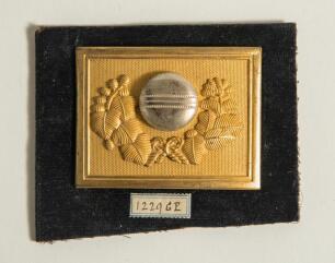 Cricket belt buckle. An excellent oblong shaped belt buckle in soft gilt metal overlaid with silver metal feature to centre, the circular centre decorated with as a large cricket ball with seam within attractive decorative laurel wreath design, attractive