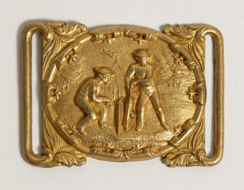 Cricket belt buckle. An excellent oblong shaped interconnecting belt buckle in soft gilt metal, the oval shaped centre features a cricket match in progress with batsman and wicket-keeper with tent and tress to background, decorative surrounds. Circa 1870.