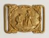 Cricket belt buckle. An excellent oblong shaped interconnecting belt buckle in soft gilt metal, the oval shaped centre features a cricket match in progress with batsman and wicket-keeper with tent and tress to background, decorative surrounds. Circa 1870.