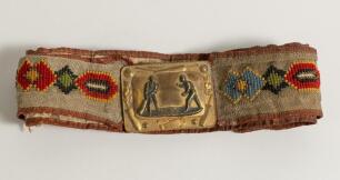 Cricket belt. Early and complete material belt with oblong shaped brass belt buckle showing a bowler and batsman to centre with border decoration of cricket bats, balls, stumps, pads and gloves. The buckle measures approximately 2.25&rdquo;x1.75&rdquo;, the belt with
