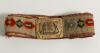 Cricket belt. Early and complete material belt with oblong shaped brass belt buckle showing a bowler and batsman to centre with border decoration of cricket bats, balls, stumps, pads and gloves. The buckle measures approximately 2.25&rdquo;x1.75&rdquo;, the belt with