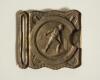 Cricket belt buckle. An almost square shaped brass belt buckle with central figure of a bowler at the wicket to central circle with crossed bat decoration to borders. Circa 1870. Approximately 2.25&rdquo; square. Good condition - 2