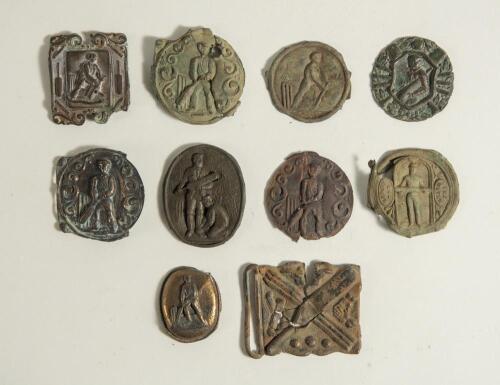 Cricket belt buckles. A selection of buckles, all with faults, and some metal band brass motifs used to decorate and enhance belt buckles. The buckles include a circular buckle with batsman at the wicket, a batsman with bat under his arm, a batsman playin