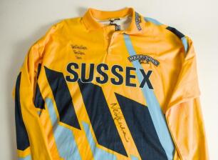 Neil John Lenham. Sussex 1984-1997. Sussex yellow &lsquo;AXA&rsquo; Sunday League shirt with blue and black trim by Hogger Sports. &lsquo;Sussex&rsquo;, martlets emblem and &lsquo;Merrydown&rsquo; sponsor&rsquo;s logo to front. Player&rsquo;s name and &lsquo;Axa&rsquo; logo to reverse. The shirt worn by Lenham in 