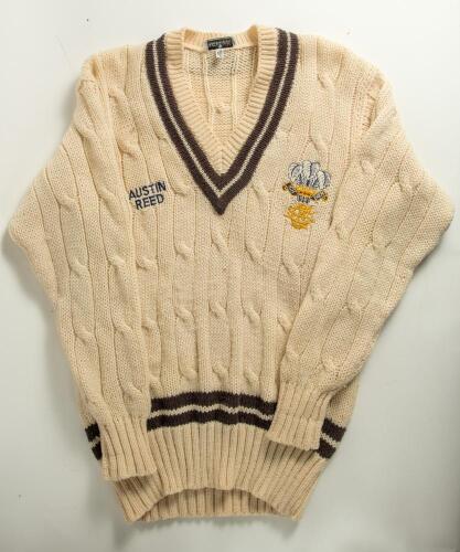 Surrey long sleeved 1st XI sweater, Kent & Curwen, with embroidered Surrey emblem of the Prince of Wales feathers and &lsquo;Austin Red&rsquo; sponsors logo to chest and trimming to neck and waist in Surrey colour of chocolate brown. Ownership unknown. Size 40&rdquo;. Good
