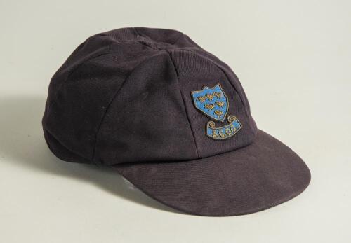 Colin Wells. Sussex 1979-1993. Sussex navy blue 1st XI cloth cricket cap worn by Wells during his playing career. The cap embroidered with the six martlet&rsquo;s emblem of Sussex to front. &lsquo;Bomber&rsquo; handwritten to inner label. Previously sold by Knights to the 