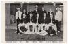 &lsquo;The Australia XI&rsquo; 1907/08. Scarce printed mono postcard of the Australian team, standing and seated in rows, wearing blazers with the umpires, Crockett and Hannah, to either side. Printed title and players&rsquo; names to top and lower borders. The team and um