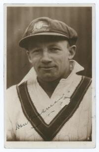 Donald George Bradman. New South Wales, South Australia & Australia 1927-1949. Excellent plain back sepia real photograph postcard of Bradman, head and shoulders, wearing Australian touring cap and sweater. The postcard very nicely signed by Bradman in in