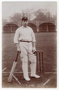 Clement &lsquo;Clem&rsquo; Hill. South Australia & Australia 1892-1925. Sepia real photograph postcard of Hill standing full length at the wicket, leaning on his bat, wearing Australia tour cap. Photograph by E. Hawkins & Co., Brighton. Postally unused. Minor wear to