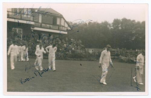 Sussex 1952. Mono real photograph plain back candid style postcard of the Sussex team entering the field of play from the pavilion with spectators looking on, for the match v Lancashire at Blackpool, 6th- 8th August 1952. The photograph signed in ink and 