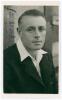 Douglas James &lsquo;Jim&rsquo; Wood. Sussex 1936-1955. Mono real photograph plain back postcard of Wood, head and shoulders wearing cricket attire and blazer. Nicely signed to the top left corner in black ink, &lsquo;Jim Wood&rsquo;. Official stamp to verso for A Wilkes & Son, 