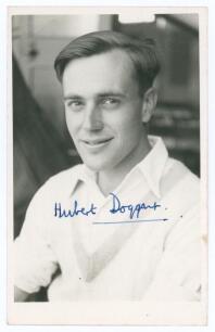 George Hubert Graham Doggart. Cambridge University, Sussex & England 1948-1961. Mono real photograph plain back postcard of Doggart, head and shoulders wearing cricket attire. Very nicely signed in blue ink by Doggart. Official stamp for A. Wilkes & Son, 