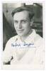 George Hubert Graham Doggart. Cambridge University, Sussex & England 1948-1961. Mono real photograph plain back postcard of Doggart, head and shoulders wearing cricket attire. Very nicely signed in blue ink by Doggart. Official stamp for A. Wilkes & Son, 