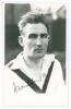 Abraham &lsquo;Abram&rsquo; Waddington. Yorkshire & England 1919-1927. Mono real photograph plain back postcard of Waddington, head and shoulders wearing cricket attire. Signed in ink by Waddington. Official stamp to verso for A. Wilkes & Son, West Bromwich. Very goo