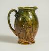 Football/Golf jug. Victorian ceramic jug with image of a footballer running with the ball to one side and a golfer and caddy to the other. Floral and bird decoration. The jug glazed in mustard and green. &lsquo;England&rsquo; to base. 6&rdquo; tall. Small chip to rim other - 2