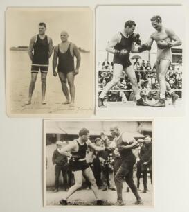 Boxing 1920s. Three original mono press photographs featuring Jack Dempsey & Stanislaus Zbyskow on a beach, Jack Dempsey sparring with George Godfrey etc. Each 10&rdquo;x8&rdquo;. Good condition. Sold with two early boxing bill postcards for bouts at the Royal Albert