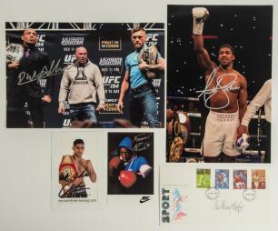 Signed boxing photographs. Two colour press photographs, one signed by Anthony Joshua, the other by Conor Mcgregor and Jose Aldo. Both 12&rdquo;x8&rdquo;. Two small signed promotional cards/ photographs of Frank Bruno and Amir Khan. Sold with a Post Office First Day 
