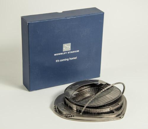 &lsquo;New&rsquo; Wembley Stadium. A pewter model of the new Wembley Stadium in original box, titled to lid &lsquo;Wembley Stadium. It&rsquo;s coming home!&rsquo;. Box measures 9&rdquo;x8.25&rdquo;x2.5&rdquo;. Sold with thirteen modern official programmes for matches played at Wembley 2007-2018 includi