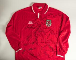Wales red replica international long sleeved football shirt from the season 1992-1994, with Welsh emblem and Umbro sponsors logo. Signed to the front by sixteen Wales internationals. Signatures include I. Rush, R. Giggs, D. Davies, M. Hughes, N. Southall,