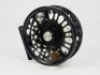 A good Abel Super 7/8N trout/salt-water fly reel, left hand wind model with black anodised finish, counter-balanced rosewood handle, multi-perforated shallow cored drum and backplate, rear spindle mounted tension adjuster, as new condition, in card box an