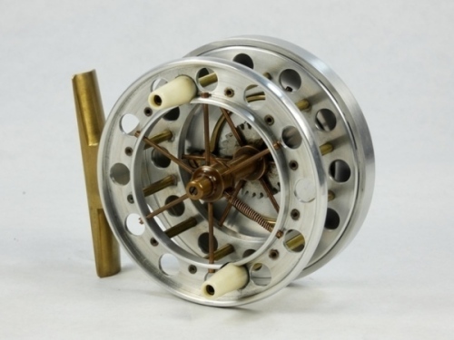 A fine David Brown Aerial style 3 ½" wide drummed centre pin reel, polished alloy finish, caged and six spoked drum with twin tapered xylonite handles, double ventilated flanges, each with twelve holes, single drum release form, brass stancheon foot, rear