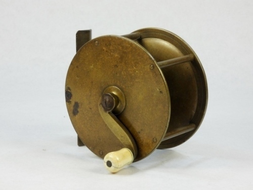 A 19th Century 4" brass wide drummed salmon winch, turned bone handle on curved crank winding arm with domed iron locking screw, block foot, triple cage pillars, rear raised check housing and fixed check mechanism, circa 1870