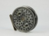A rare Hardy Davy 3 ½" trout fly reel, contracted drum with multi-perforated front plate, twin ebonite handles and nickel silver telephone drum latch, ribbed brass foot, , rim mounted milled tension screw and Mk.II check mechanism, backplate stamped mak