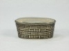 A scarce Victorian sterling silver vesta case in the form of a woven reed fishing creel, tapered oval form, hinged lid with relief decoration of a naturalistically painted trout lain upon on a grassy bank within a gilt border and beneath a cut and bevelle