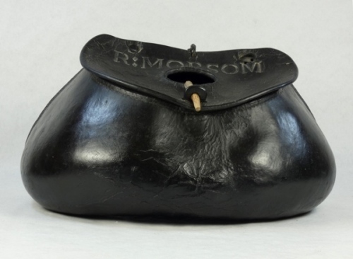 A fine and rare 18th Century steamed leather pot-bellied trout fisher's creel, hand stitched swollen base with two rear and two lower belt loops, brass hinged lid with oval fish hole, leather tab latch and stamped previous owners name "R. Morsom", one lid