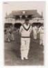 Scarborough Cricket Festival 1935. H.D.G. Leveson-Gower's XI v South Africans, 7th- 9th September 1935. Mono real photograph plain back postcard of the South African Captain, H.B. Cameron, standing full length wearing wicketkeeping attire, the pavilion in