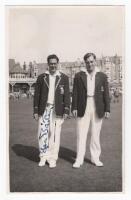 Scarborough Cricket Festival 1955. Yorkshire v M.C.C., 31st August- 2nd September 1955. Mono real photograph plain back postcard of Trevor Bailey and Doug Insole of the M.C.C. team standing side by side wearing cricket attire and blazers, the pavilion in 