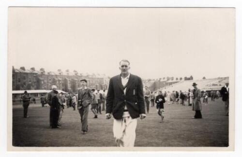 Scarborough Cricket Festival 1956. Mono real photograph plain back postcard of Johnny Wardle walking off the pitch wearing cricket attire and blazer, spectators milling around on the outfield in the background. Match unknown. Assumed to be by Walkers Stud