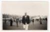 Scarborough Cricket Festival 1956. Mono real photograph plain back postcard of Johnny Wardle walking off the pitch wearing cricket attire and blazer, spectators milling around on the outfield in the background. Match unknown. Assumed to be by Walkers Stud