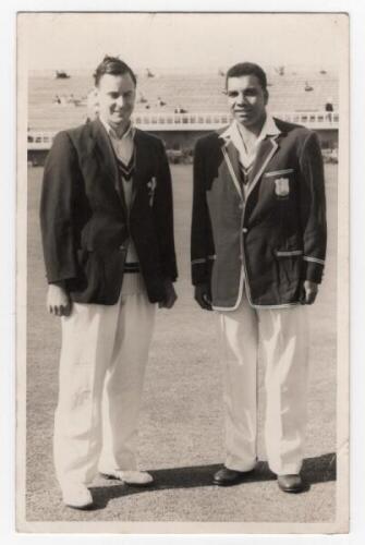 Scarborough Cricket Festival 1957. T.N. Pearce's XI v West Indians, 7th- 10th September 1957. Mono real photograph plain back postcard of the captains, Peter May and Clyde Walcott, standing together full length wearing cricket attire and blazers, the gran