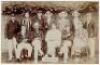 'Sussex XI' c.1905. Sepia real photograph postcard of the Sussex team seated and standing in rows wearing cricket attire and assorted blazers and headgear. To the centre is the captain, C.B. Fry. Blind embossed stamp for Foster of Brighton to lower right 