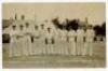 Hampshire C.C.C. Bournemouth Cricket Week 1913. Mono real photograph postcard of the Hampshire team standing in one row wearing cricket attire on the field with a marquee and spectators in the background. Players featured are White, Tennyson, Jaques, McDo