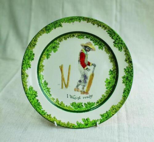 'I Was'nt Ready'. A Royal Doulton 'Black Boy' bone china dinner plate, entitled 'I Was'nt ready' printed with a boy in red shirt, waistcoat and a floppy yellow hat looking glum with his wicket broken behind him. Green floral decoration to inner and outer 