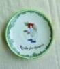 'Ready for Chances'. Royal Doulton Black Boy saucer, entitled 'Ready for Chances' printed with a boy in red shirt, yellow waistcoat and a floppy hat crouched awaiting a catch (as if in the slips). Green floral decoration to edge. 5.5" diameter. Doulton ba